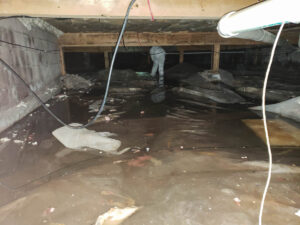 A crawl space filled with water after a pipe break.